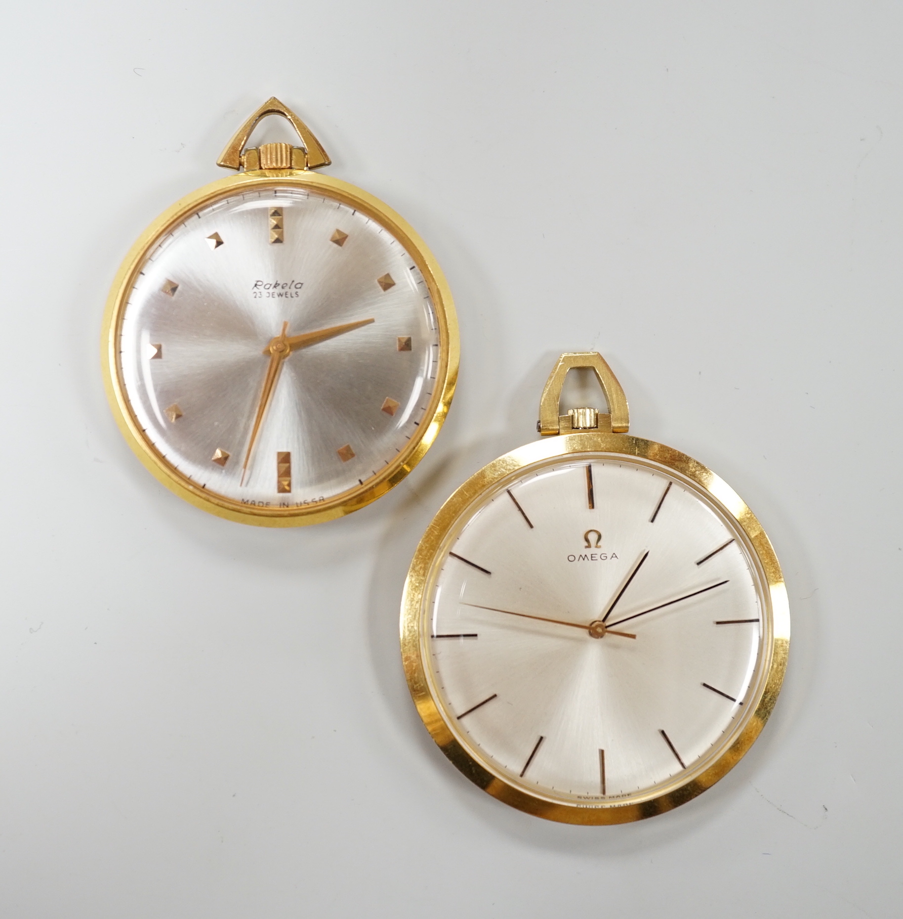 A 750 yellow metal Omega open faced keyless dress pocket watch, case diameter 42mm, gross weight 43.1 grams and a Rukela dress pocket watch.